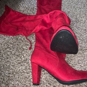 Red knee high heeled boots